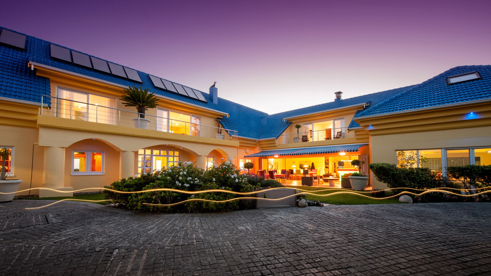 Luxury home with light streaks in foreground.